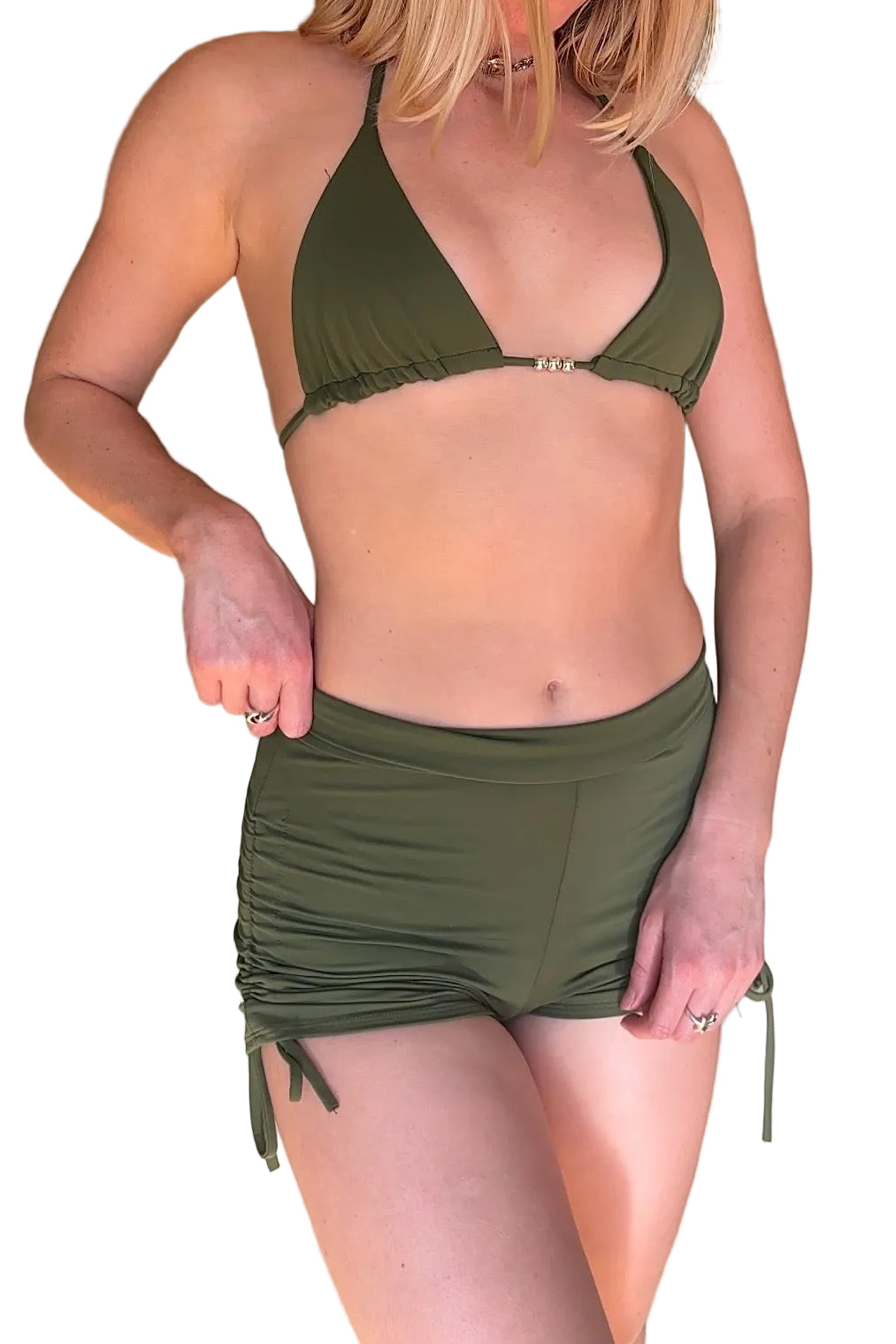 Person wearing an olive green bikini with a matching skirt against a neutral background