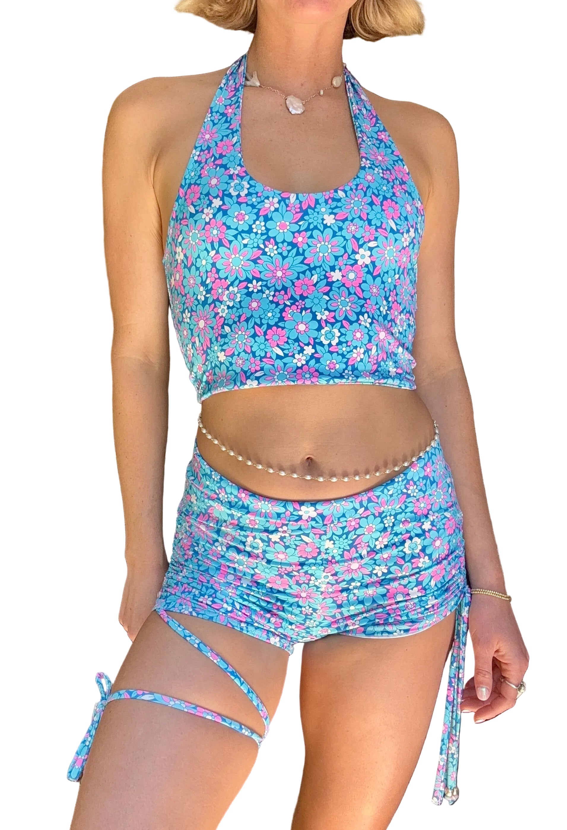 Person wearing a blue floral two-piece swimsuit indoors.